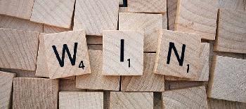 a word 'win' made of three wood playing blocks