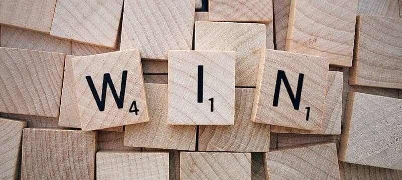 a word 'win' made of three wood playing blocks